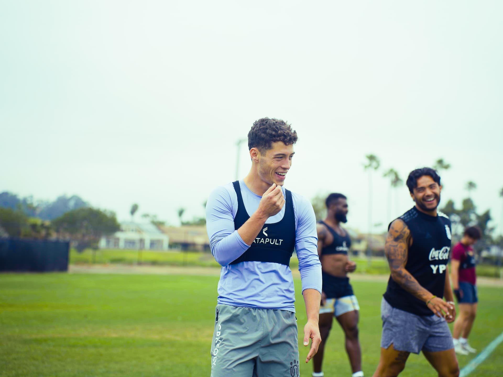 Coach timing an athlete during a speed session